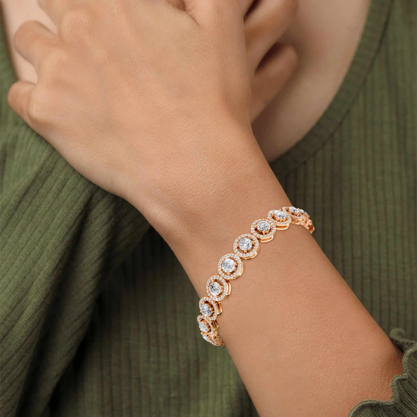 The bracelet graces the wrist with regal presence, its halo diamonds radiating fire against a backdrop of soft rose gold.