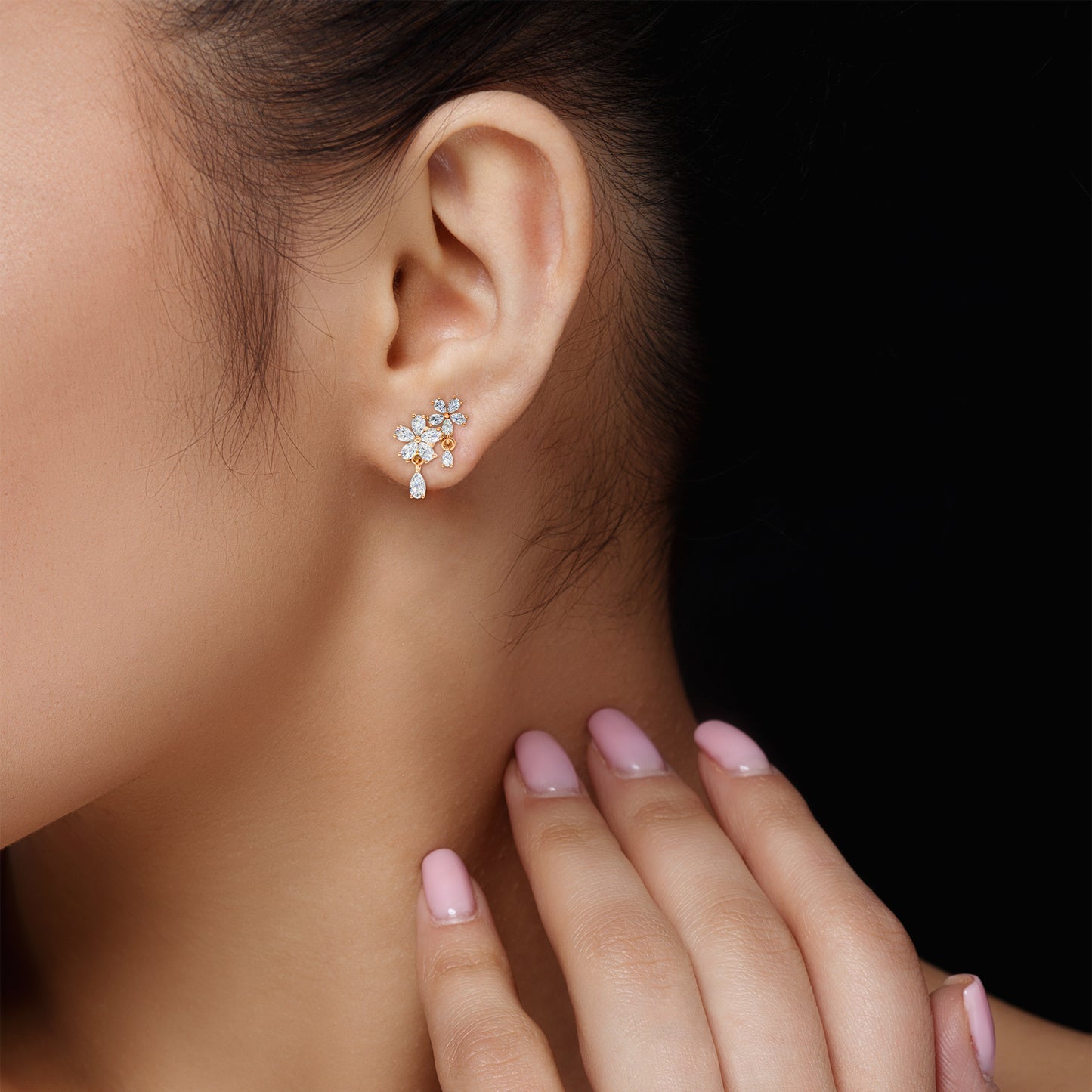 Close-up of Floral Cascade Diamond Earrings in 18K rose gold, detailing the brilliance of 3.20 ct lab-grown pear-shaped diamonds, worn by a brown-haired model.