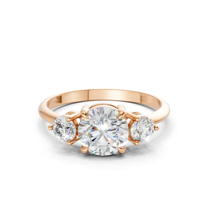 Frontal view of the Triple Shine 1.3 CT Diamond Ring in rose gold, showcasing a radiant trio of diamonds elegantly set in a softly glowing blush-toned band.