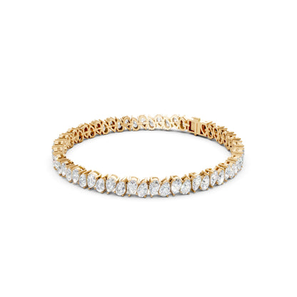 Side view of the Pear Radiance Bracelet, displaying the sleek profile of 7.95 ct pear-cut diamonds set in 18K yellow gold, showcasing the bracelet’s elegant curvature.