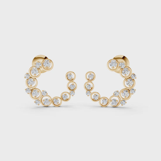 Graceful slow-motion spin highlighting the earrings’ dimensional curve, shimmering stones, and golden luster.