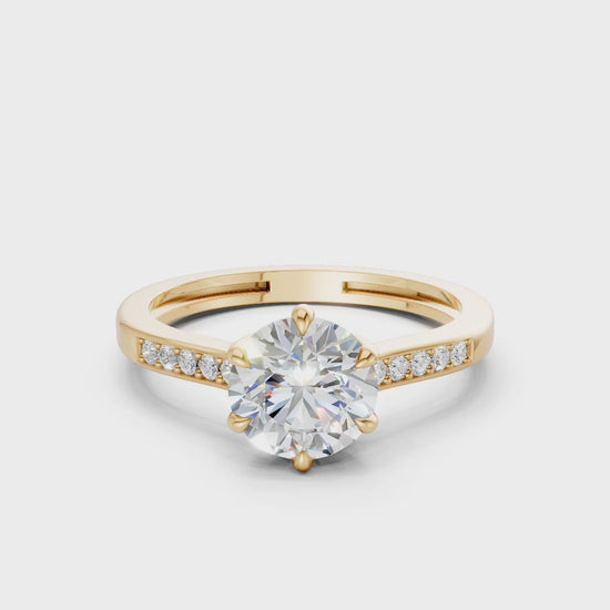 Smoothly rotating video showing crisp reflections from the princess-cut diamond and the golden finish of the band.