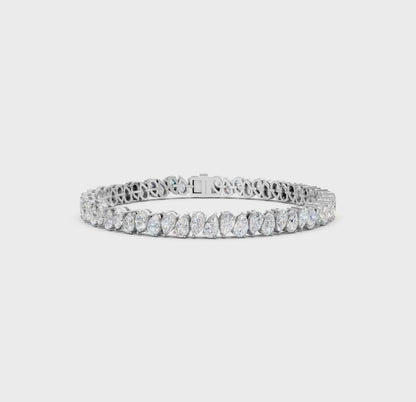 Short video showcasing the Pear Radiance Bracelet, featuring 7.95 ct pear-cut diamonds in 18K white gold, rotating to display its sparkling design and luxurious craftsmanship.