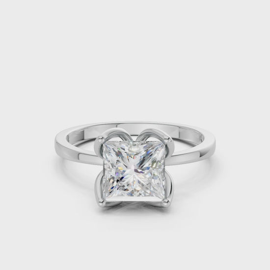Softly rotating footage highlighting the light play across each facet and the ring’s lustrous white gold structure.