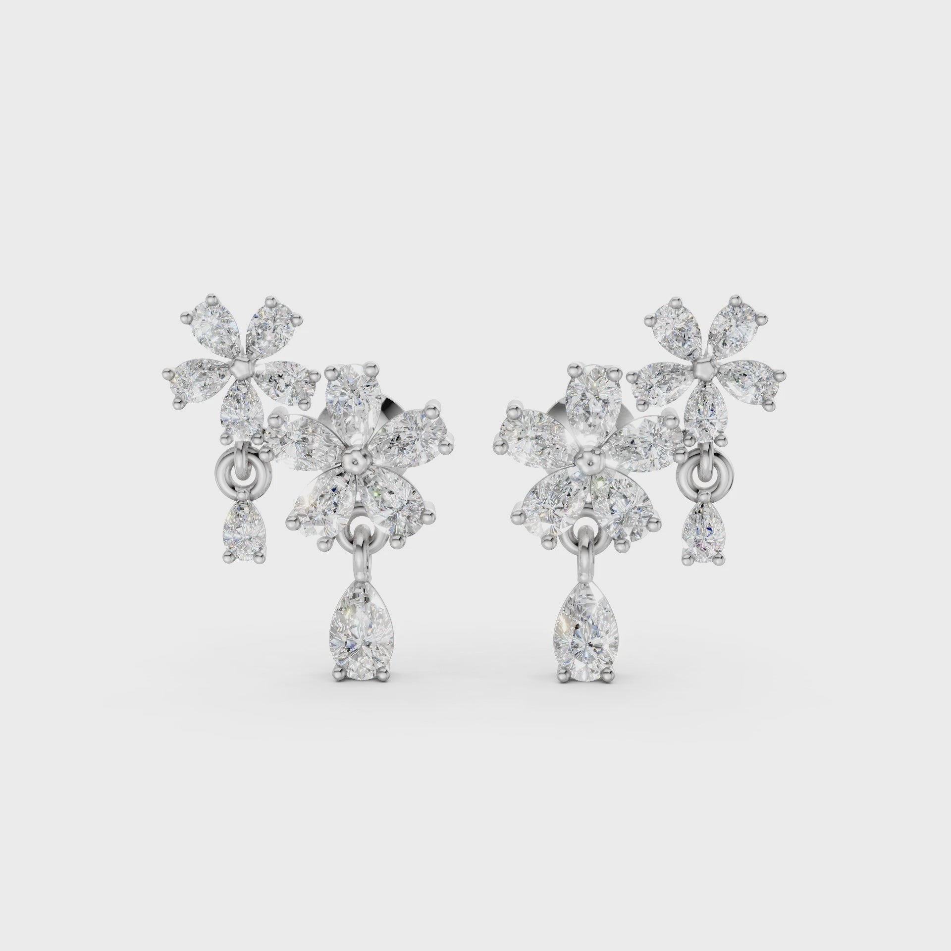 Short video of Floral Cascade Diamond Earrings in 18K white gold, featuring 3.20 ct lab-grown diamonds, rotating to showcase the cool tone and sparkling layered blossom design.