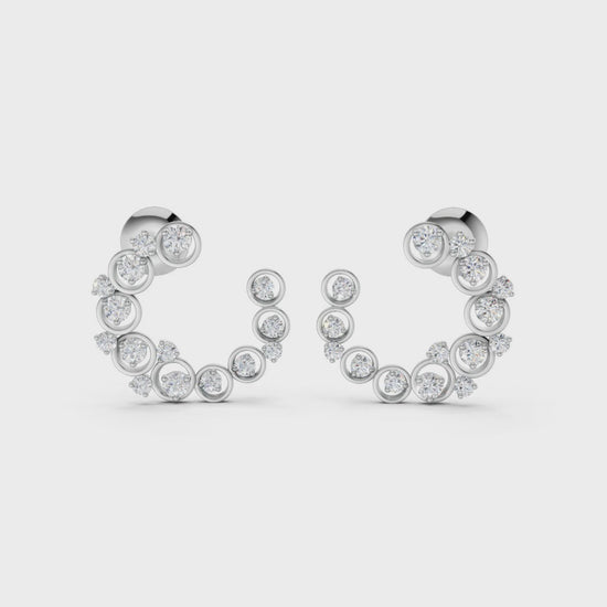 Slow-motion rotation capturing the movement, sparkle, and sculptural depth of the halo earrings in polished white gold.