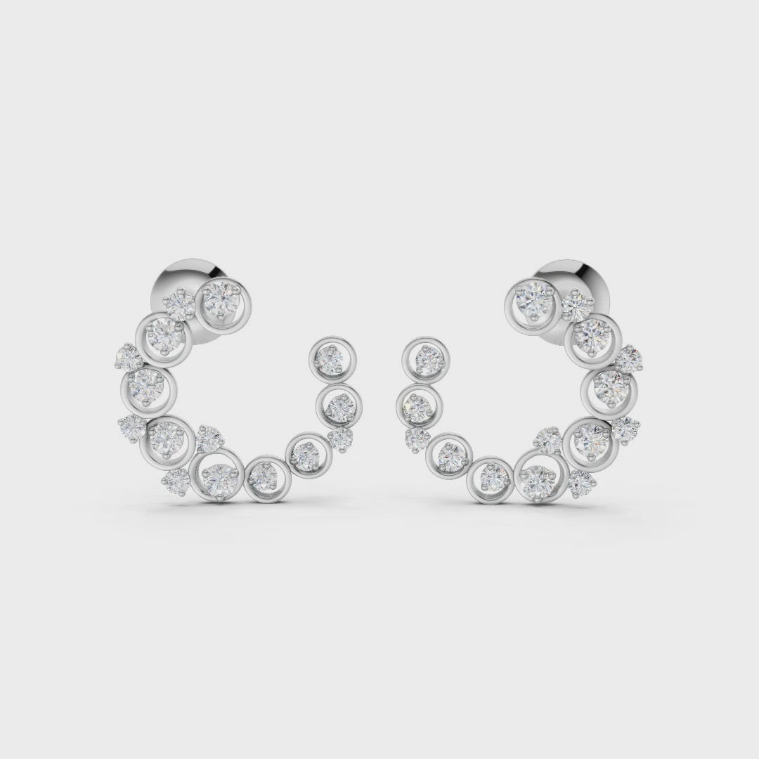 Slow-motion rotation capturing the movement, sparkle, and sculptural depth of the halo earrings in polished white gold.