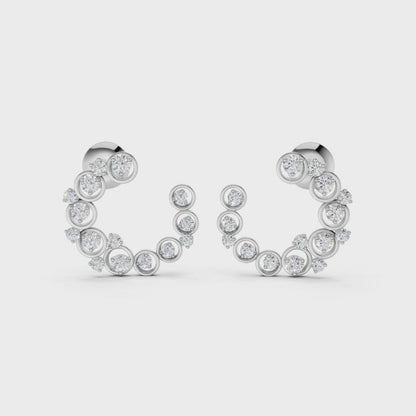 Slow-motion rotation capturing the movement, sparkle, and sculptural depth of the halo earrings in polished white gold.