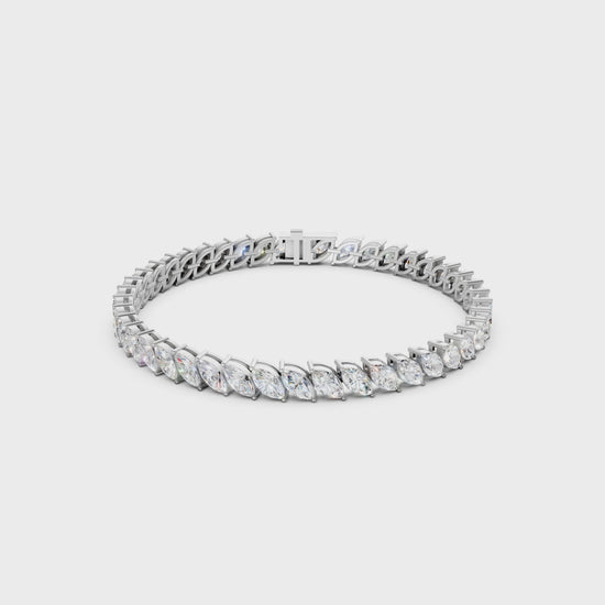 Smooth rotating clip capturing the interplay of fire and reflection between marquise facets and polished white gold.