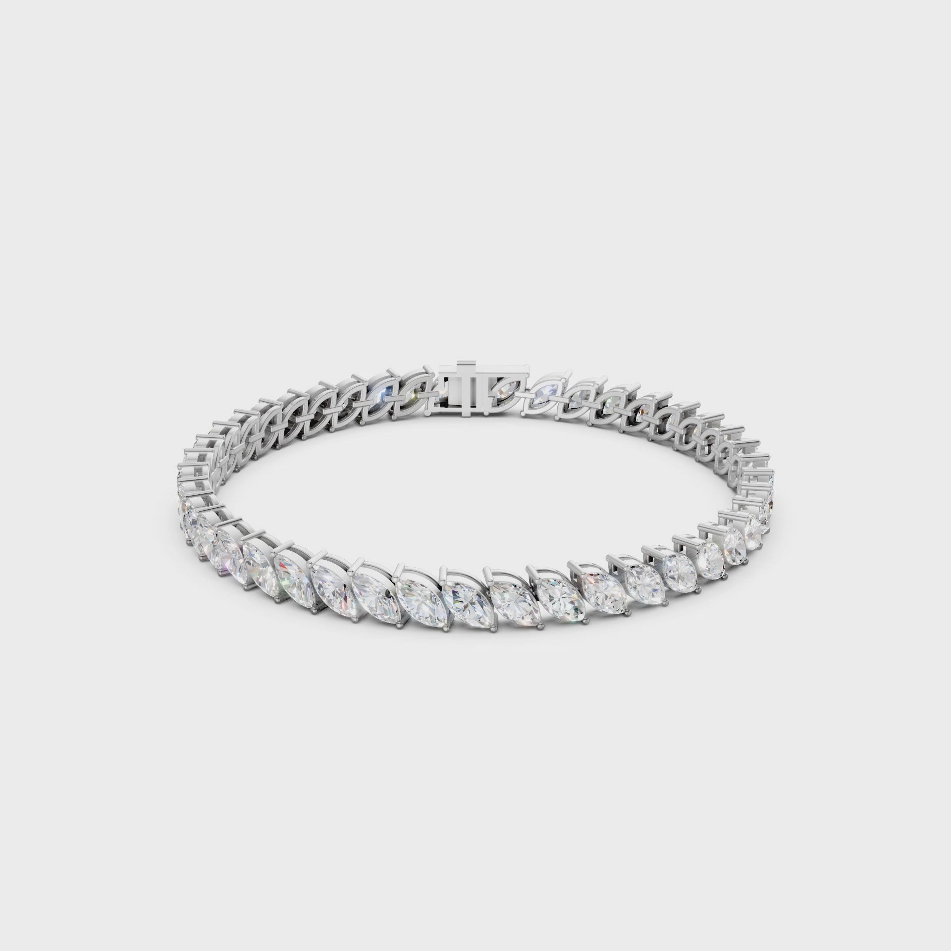 Smooth rotating clip capturing the interplay of fire and reflection between marquise facets and polished white gold.
