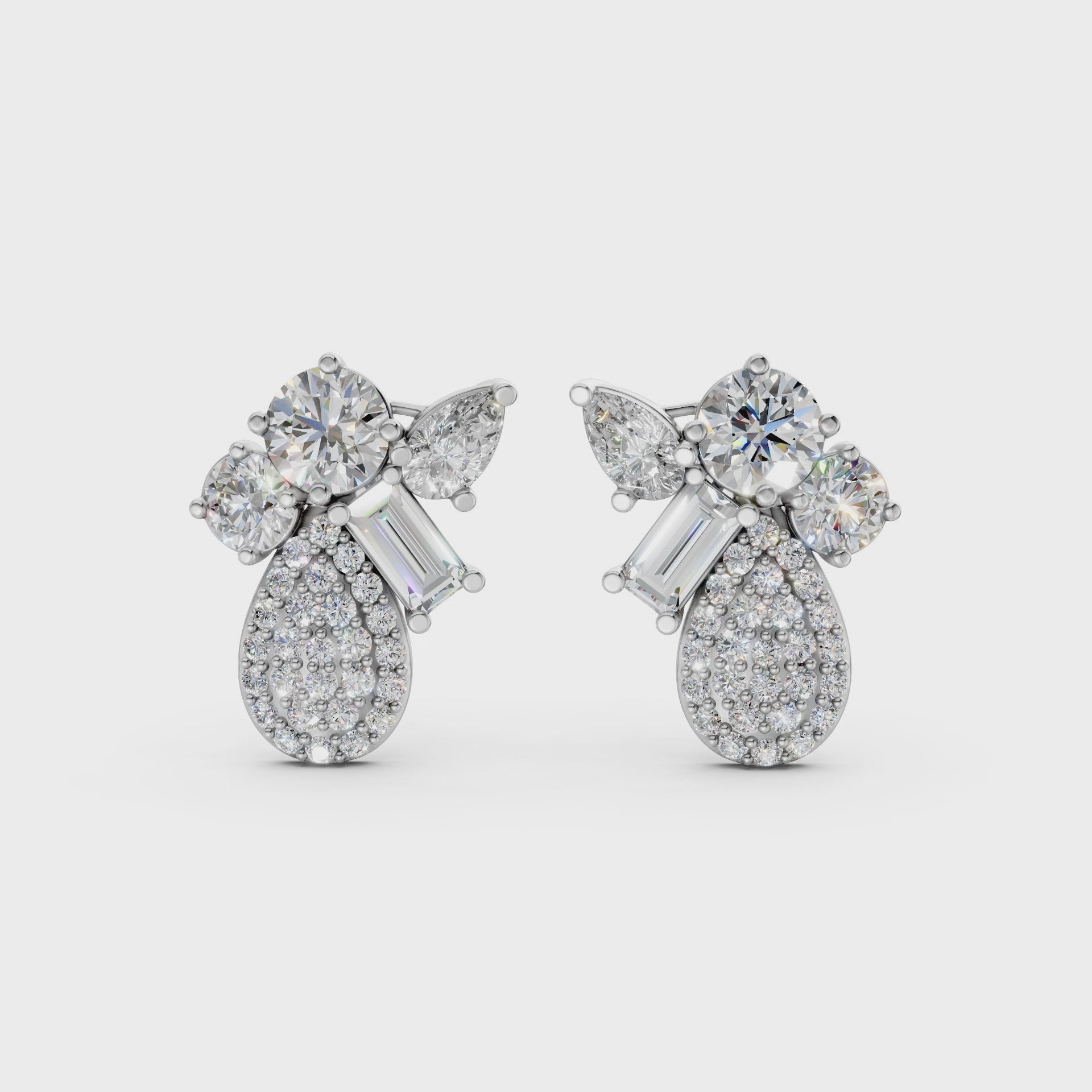 Short video of Modern Teardrop Cluster Diamond Earrings in 18K white gold, featuring 2.368 ct lab-grown diamonds, rotating to showcase the cool hue and sparkling teardrop cluster.